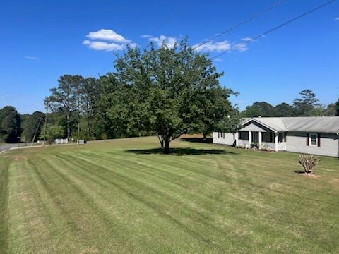 Wide striped lawn maintenance on a Georgia ranch property